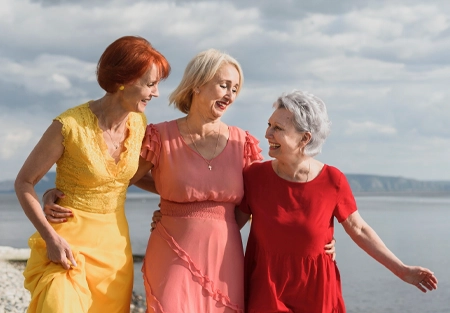 Older women walking together on a beach