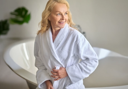 Smiling older woman in a white robe