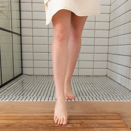 Bare feet on a bathroom floor at night
